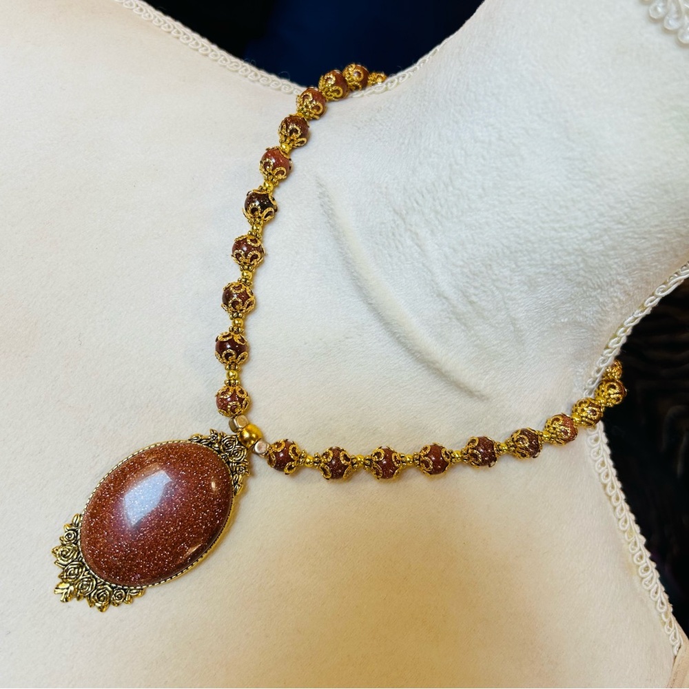 Handcrafted elegant goldstone cameo framed bead necklace